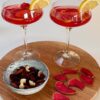 RCR Aria Champagne Coupe 33 cl (6 pcs) with a red drink and orange garnish